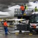 Workers fuel an Air France-KLM A350 with sustainable aviation fuel
